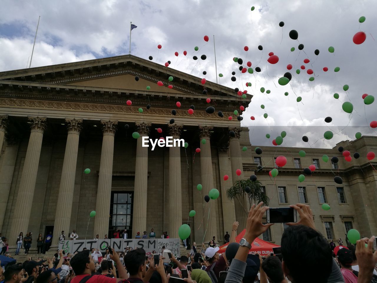 PEOPLE AT MUSIC CONCERT AGAINST SKY IN CITY