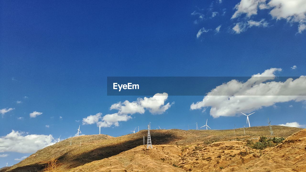 Low angle view of field against blue sky