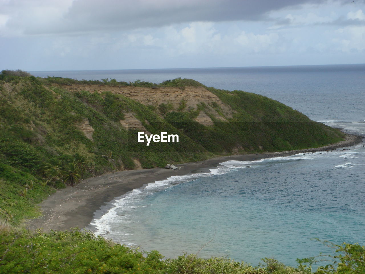 Scenic view of mountain by sea at saint kitts
