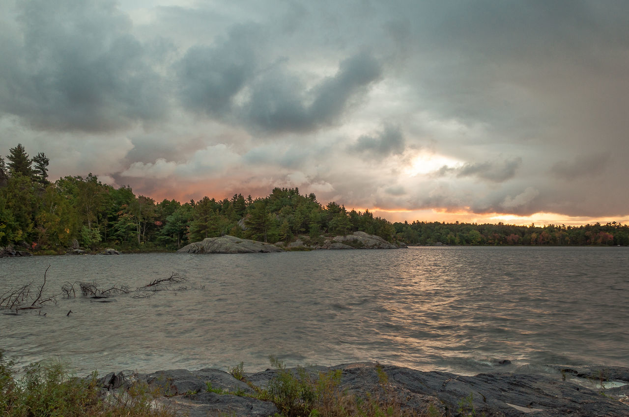 Scenic view of calm sea against cloudy sky