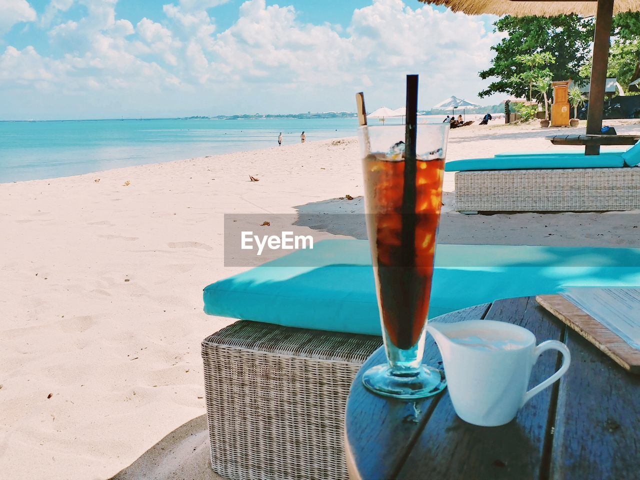 Close-up of drinks on table at beach