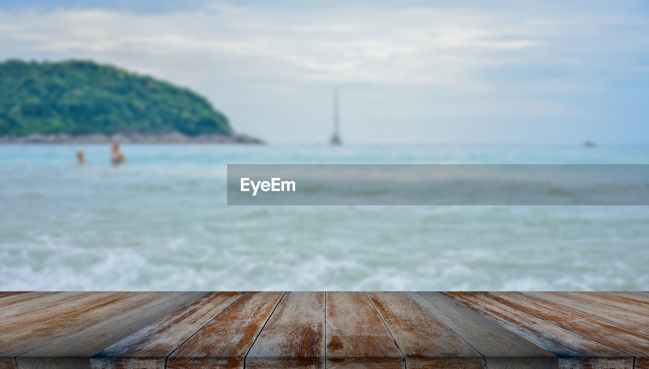 water, sea, shore, sky, ocean, coast, wood, land, nature, beauty in nature, scenics - nature, day, beach, cloud, horizon, body of water, tranquility, pier, tranquil scene, wave, bay, outdoors, vacation, horizon over water, jetty, sand, focus on foreground, idyllic, no people, non-urban scene, travel destinations, nautical vessel