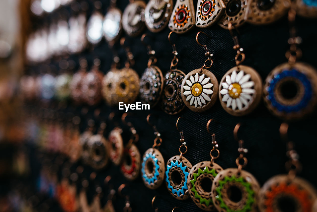 CLOSE-UP OF DECORATIONS HANGING FOR SALE IN MARKET