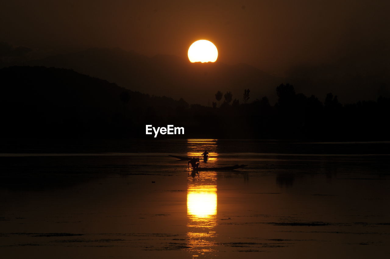 SCENIC VIEW OF LAKE DURING SUNSET