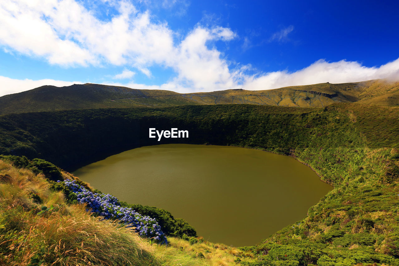 Scenic view of mountains against blue sky