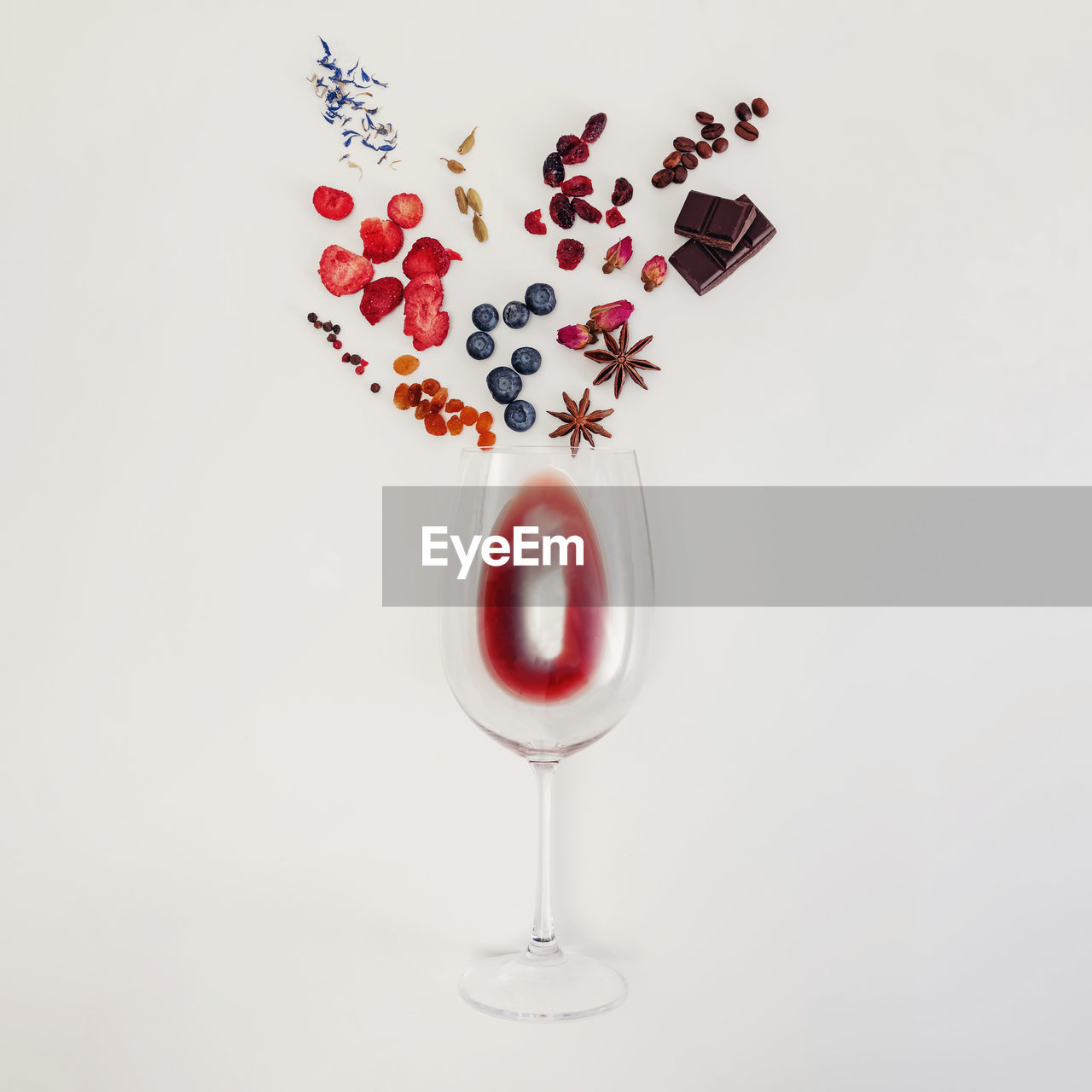 Still life composition with wine glass and possible flavors of red wine. flat lay composition