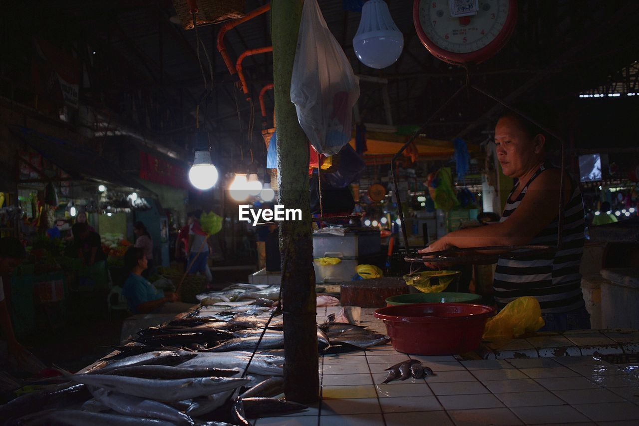 PEOPLE AT MARKET STALL IN CITY