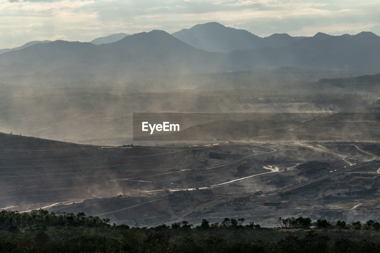 Scenic view of landscape and mountains against sky