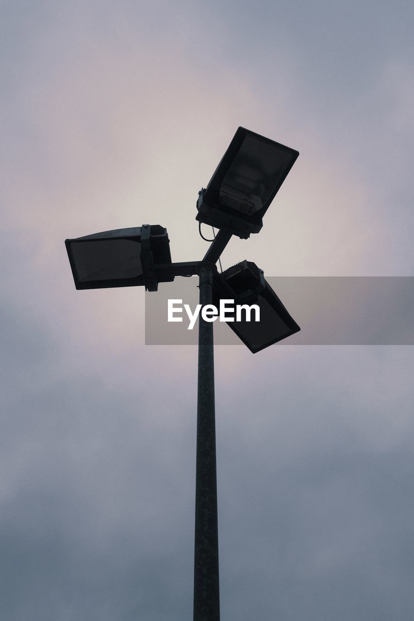 Low angle view of security camera against sky