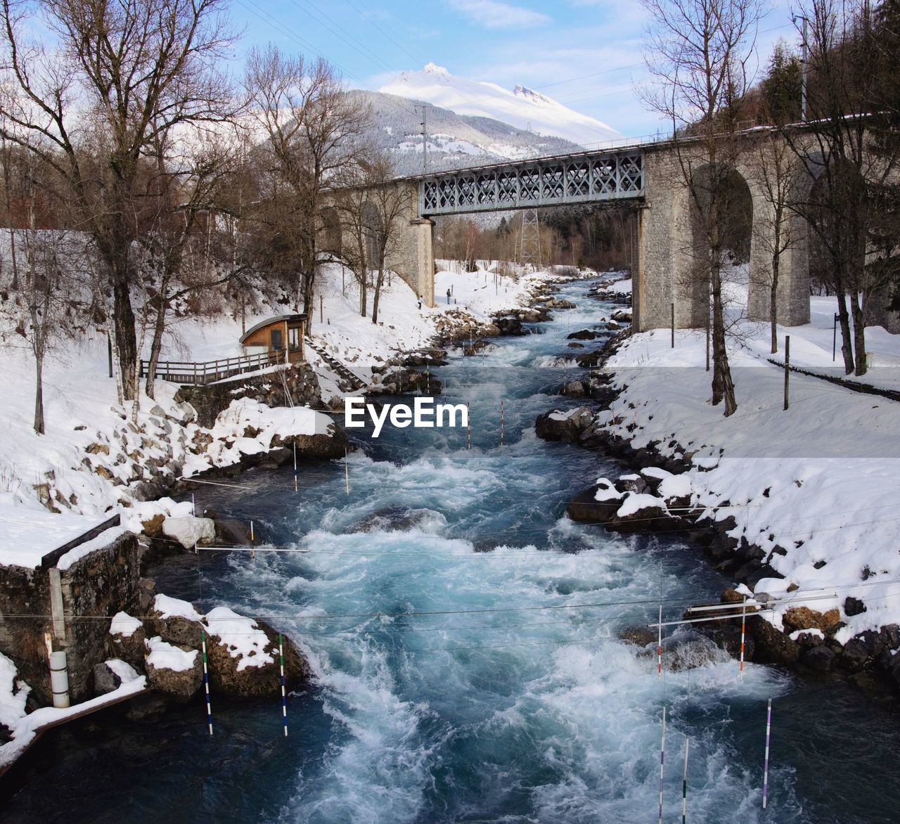 Bridge over river during winter