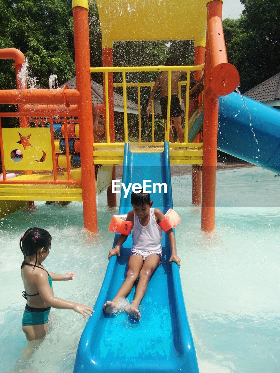 CHILDREN PLAYING ON SWIMMING POOL