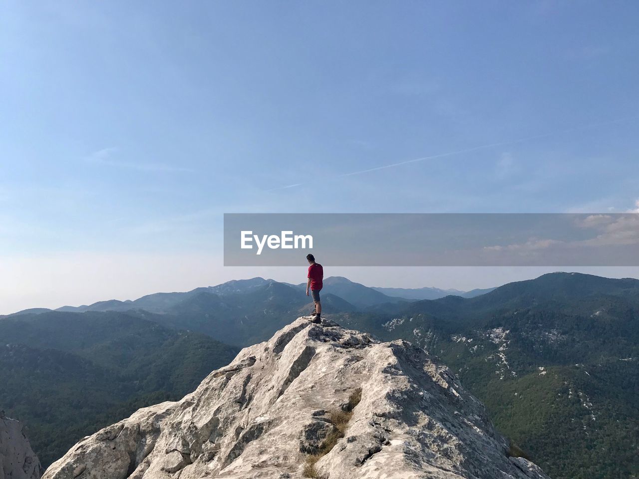 Full length of man standing on mountain against sky