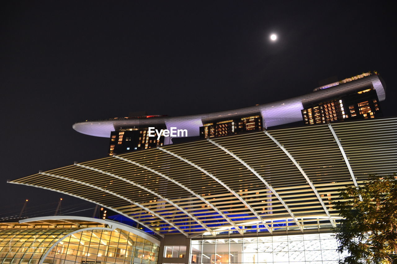 LOW ANGLE VIEW OF ILLUMINATED BUILT STRUCTURE AGAINST SKY