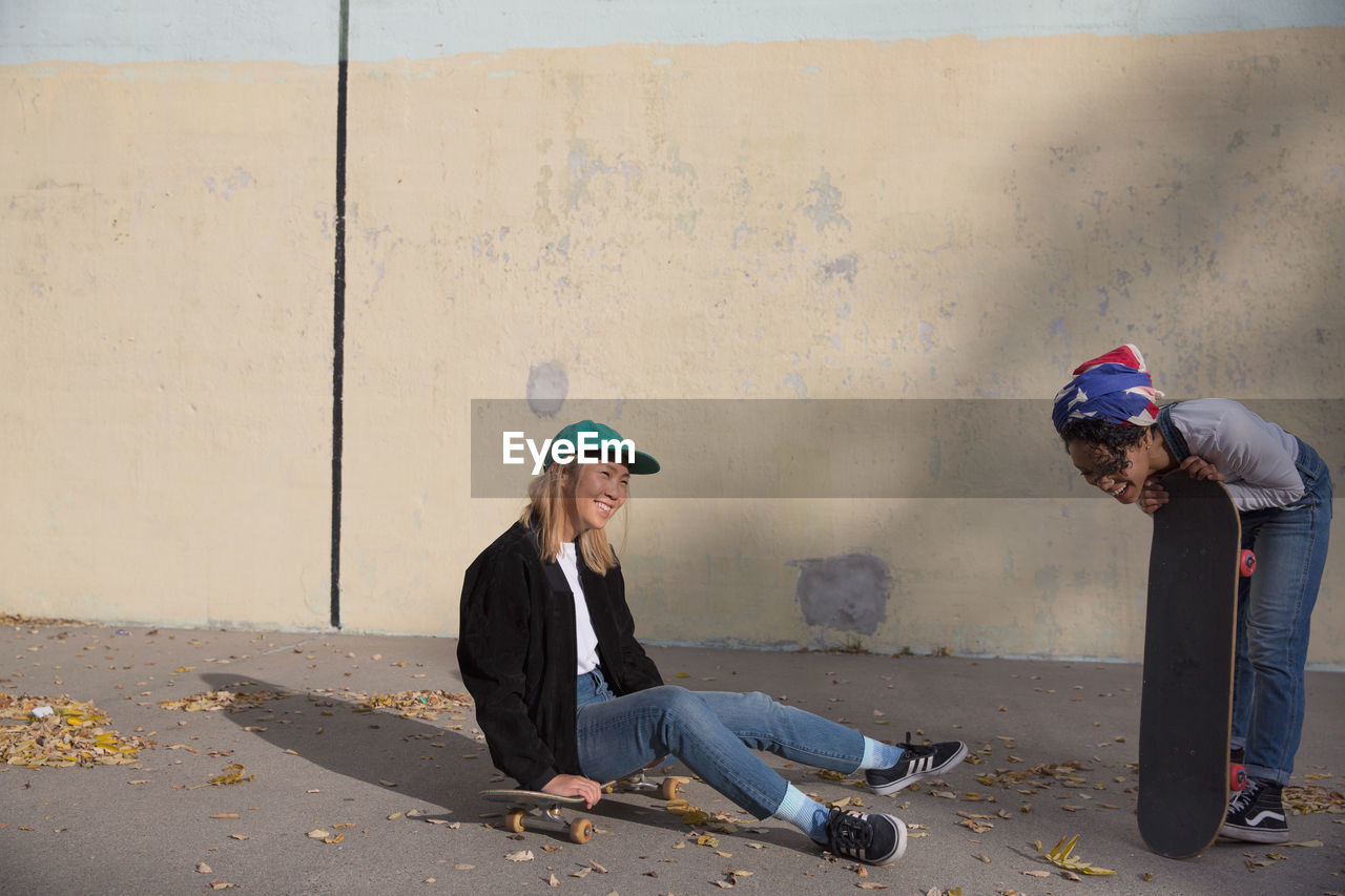 Two young women with skateboards