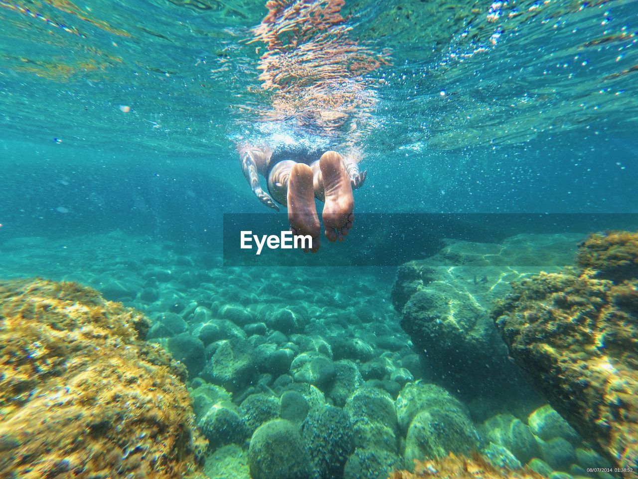 Low section of man swimming in sea