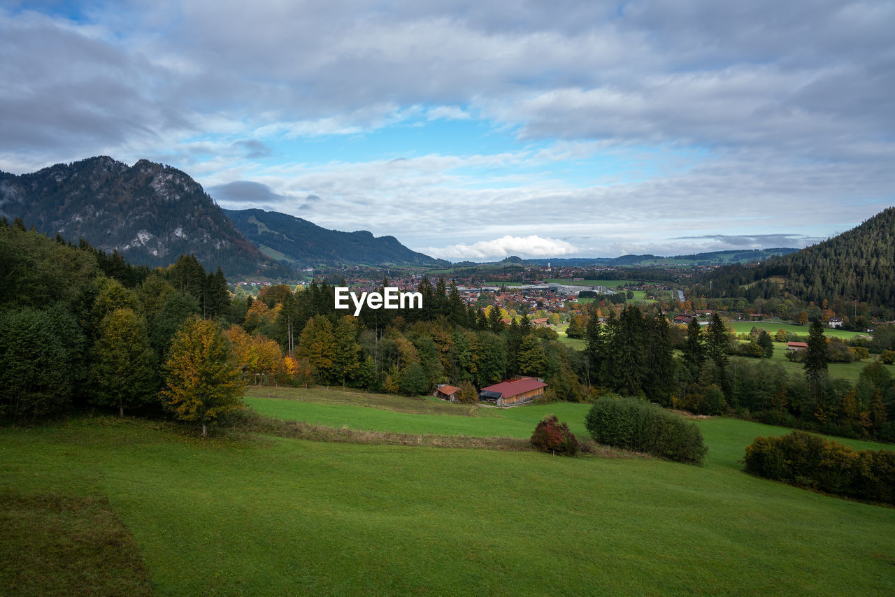 Scenic view of field and mountains against sky