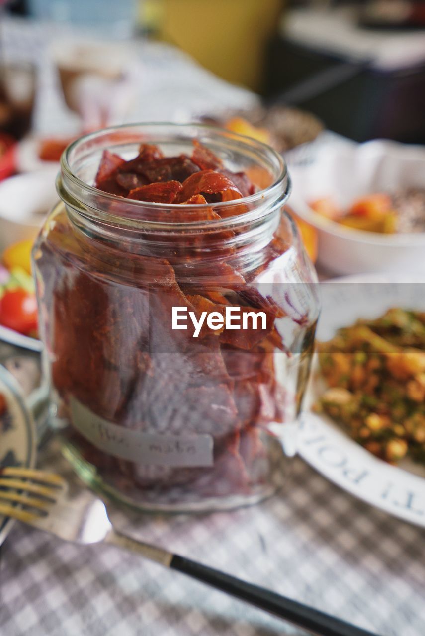 HIGH ANGLE VIEW OF JAR ON TABLE