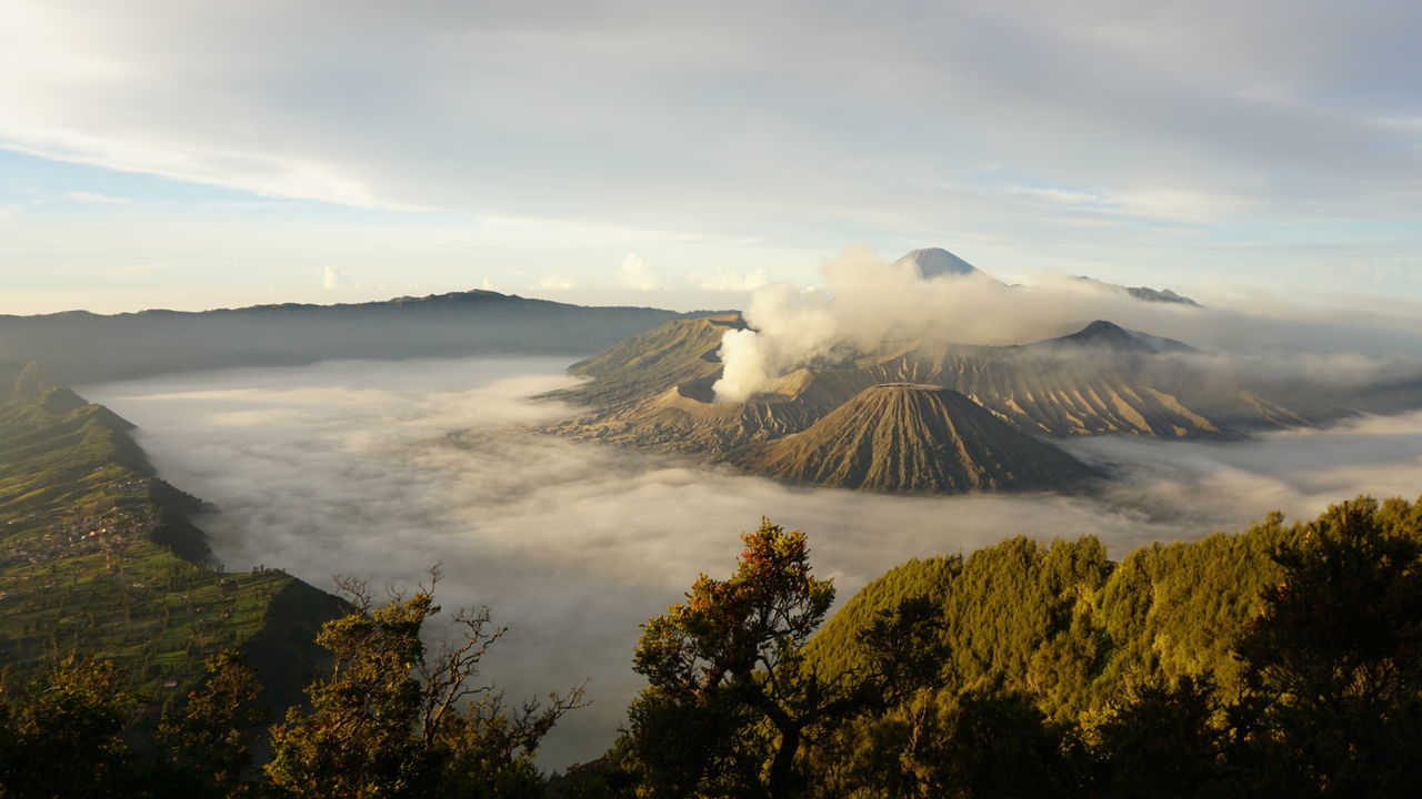 View of volcanic landscape against cloudy sky