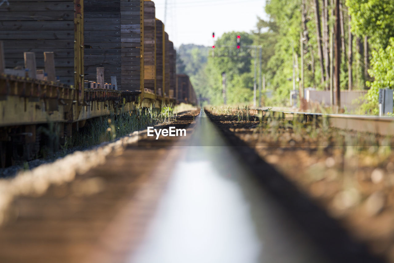 Train on railroad track during sunny day