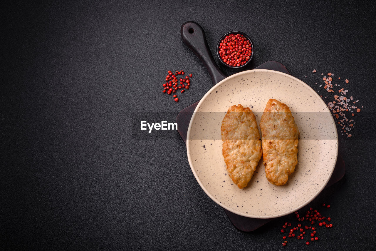 food and drink, food, freshness, healthy eating, indoors, sweet food, no people, directly above, wellbeing, still life, baked, produce, plate, high angle view, studio shot, dessert, fruit, copy space, cookie, black background, table, sweet, gray, spice