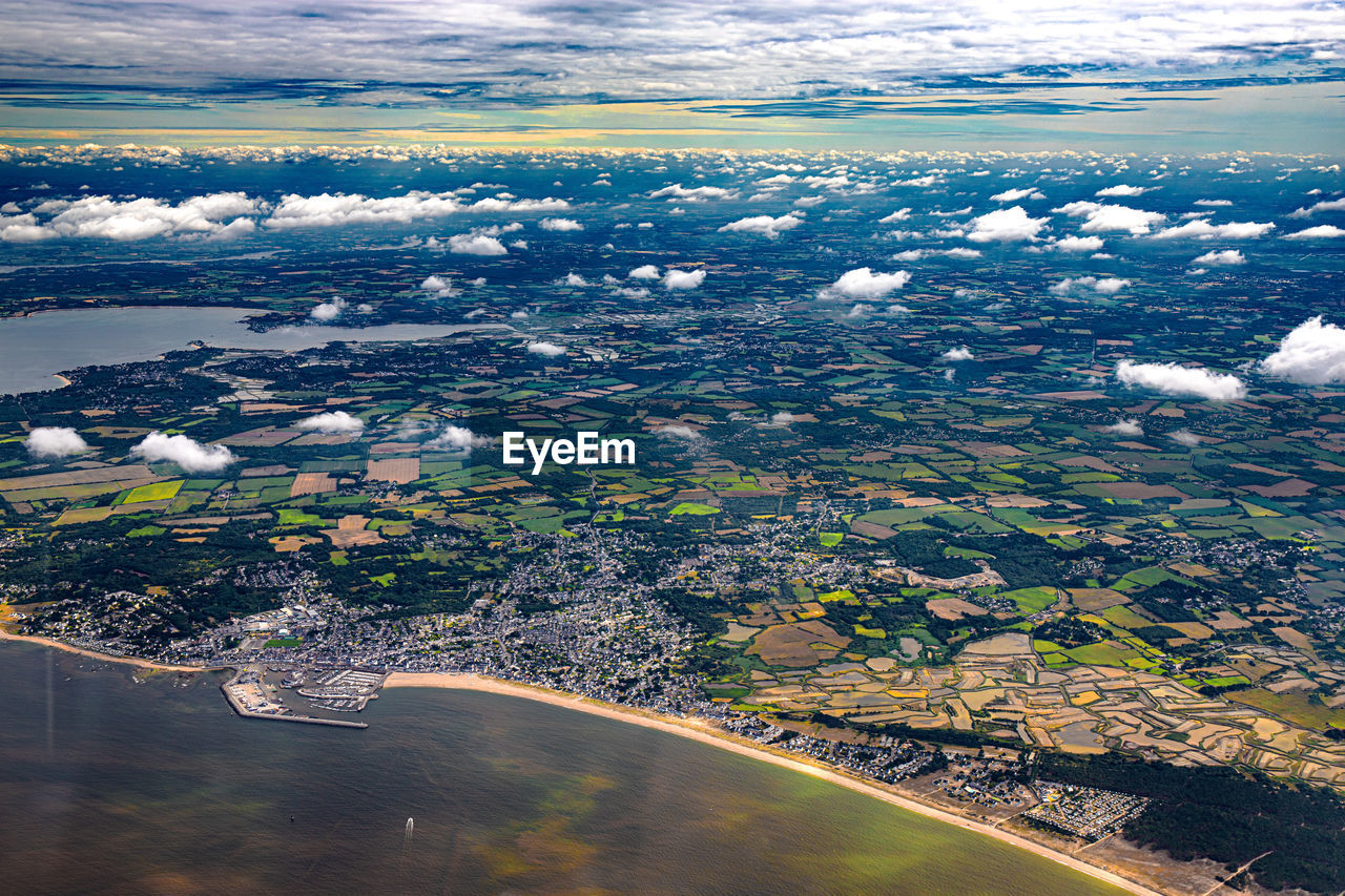 aerial photography, aerial view, water, environment, horizon, landscape, nature, coast, reflection, sea, travel, scenics - nature, land, travel destinations, cloud, sky, city, no people, beauty in nature, architecture, tourism, outdoors, air vehicle, airplane, high angle view, transportation, beach, flying, day, social issues, coastline, tranquility, lagoon, building exterior, cityscape, building, island, ocean, trip, built structure, vacation, rural scene, bird's-eye view, blue, tranquil scene, cold temperature