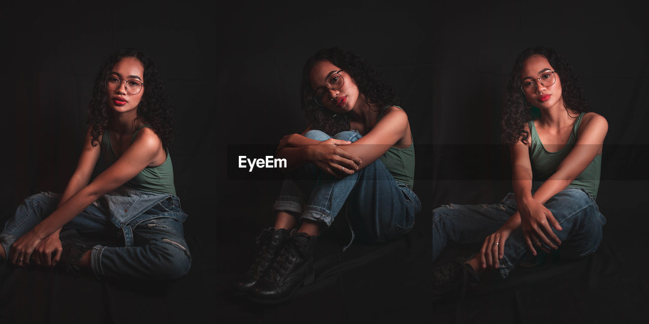 YOUNG WOMAN SITTING IN THE DARK ROOM