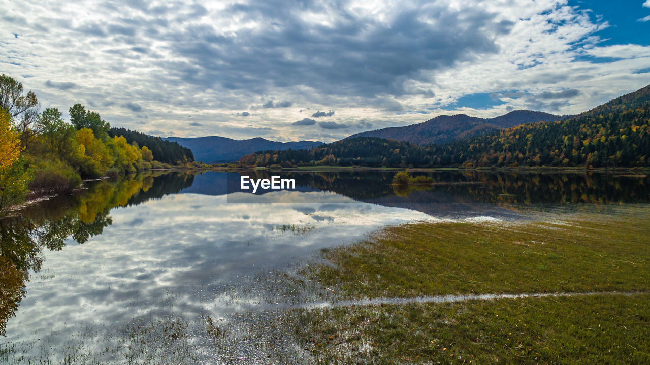 SCENIC VIEW OF LAKE BY TREES AGAINST SKY