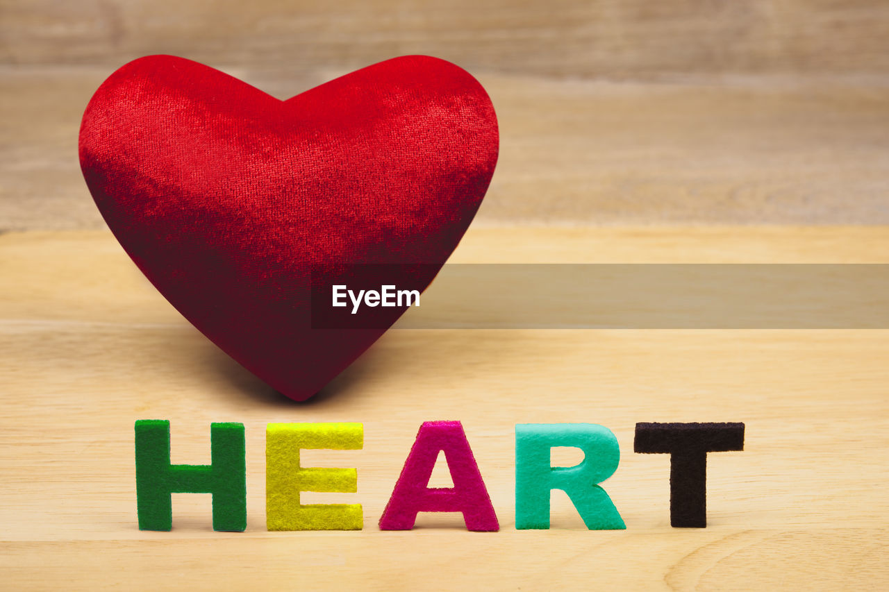 Close-up of heart shape decoration with text on table