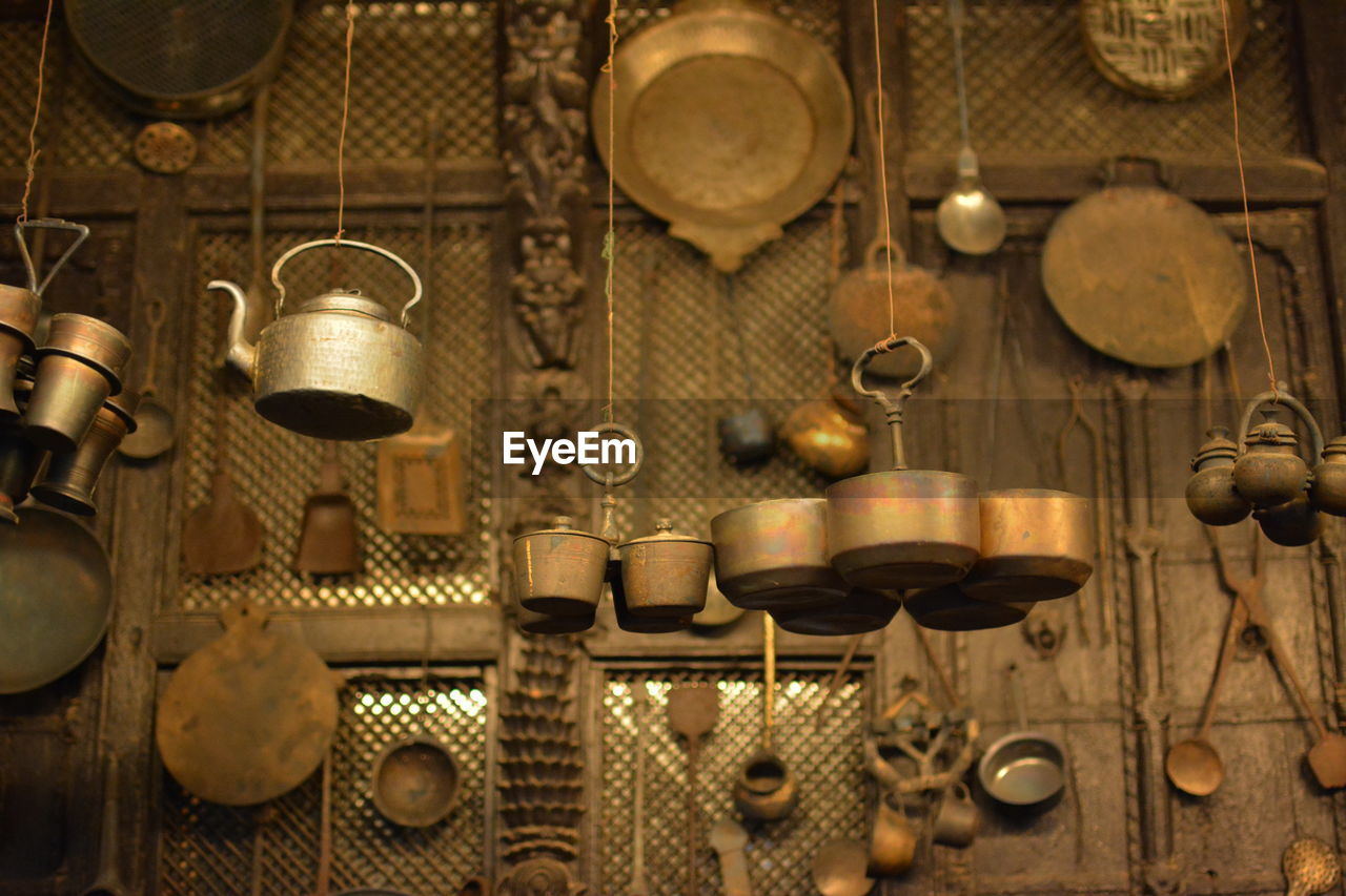 Close-up of antiques for sale hanging at store