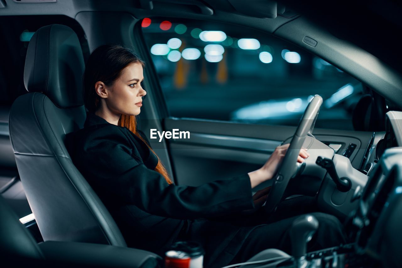 Young woman sitting in car