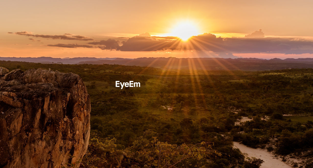 Scenic view of landscape against sky during sunset