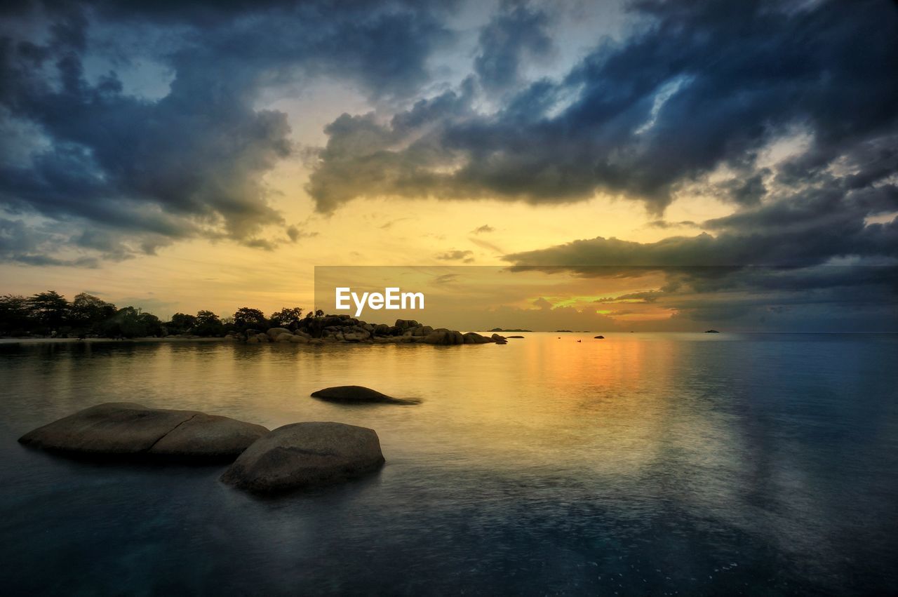 Scenic view of lake against sky during sunset