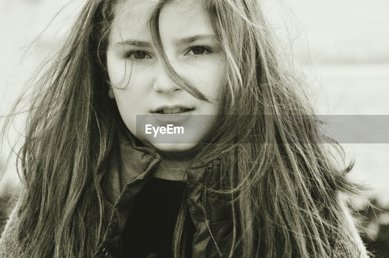 Close-up portrait of teenage girl with long hair