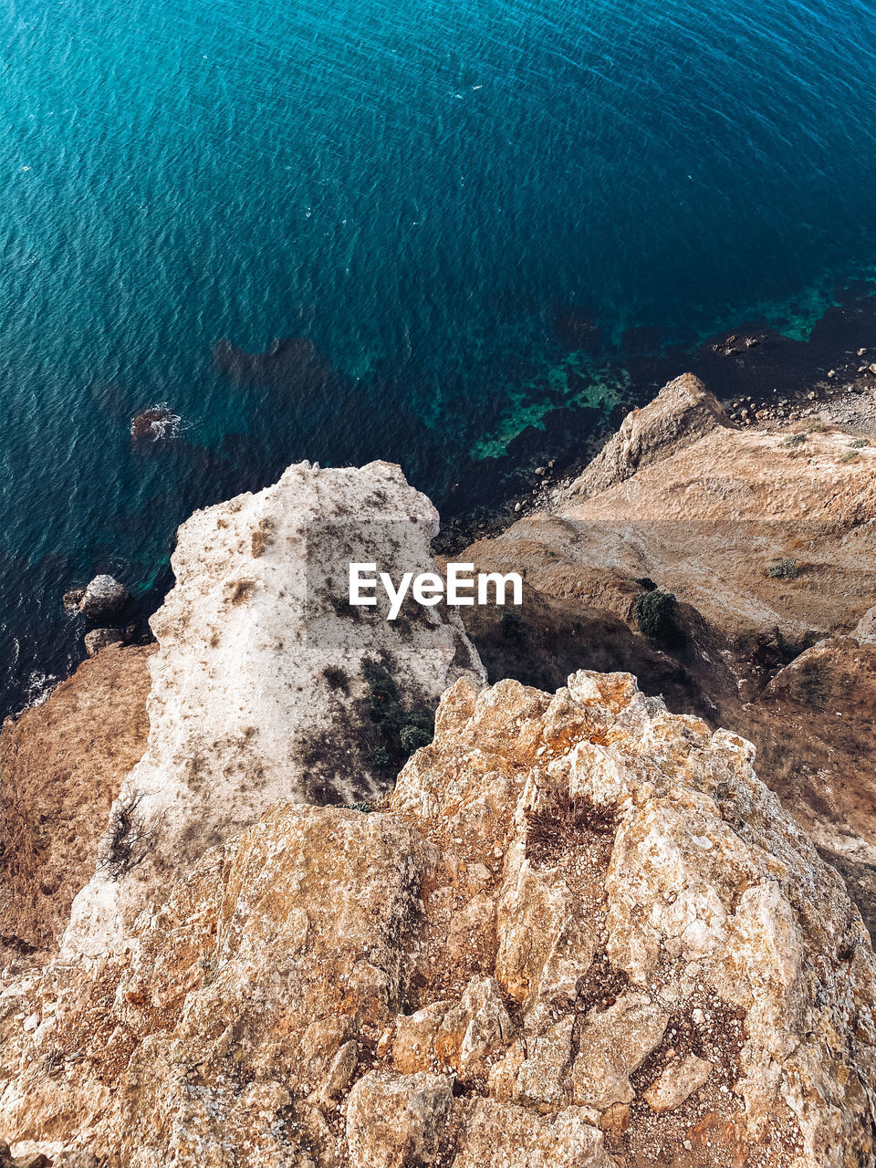 High angle view of rocks by sea