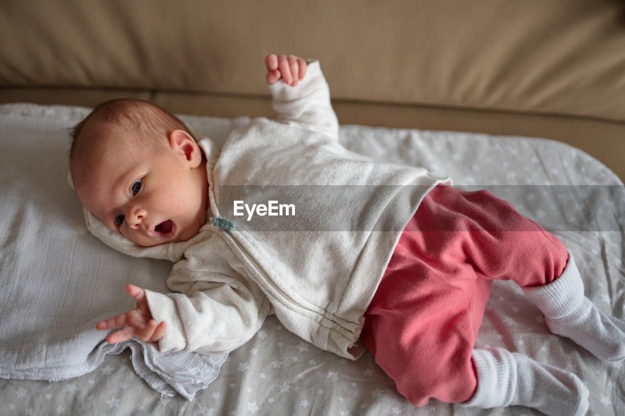 Portrait of cute newborn baby lying on blanket