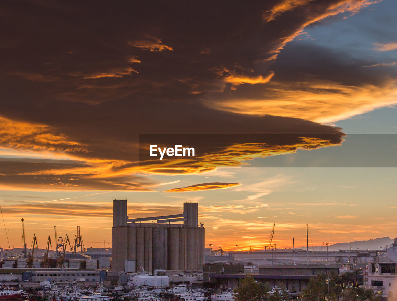 Buildings in city during sunset