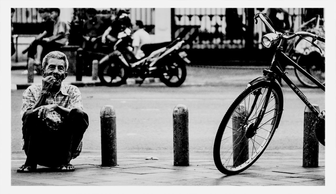 PEOPLE RIDING BICYCLE IN PARKING LOT