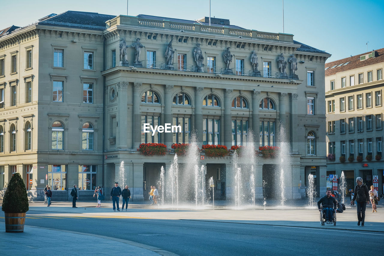 VIEW OF FOUNTAIN IN FRONT OF BUILDINGS