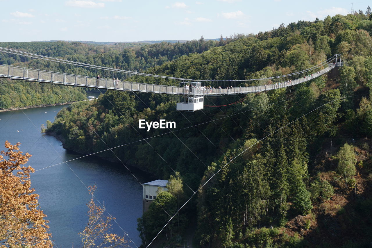 Low angle view of bridge over river against sky