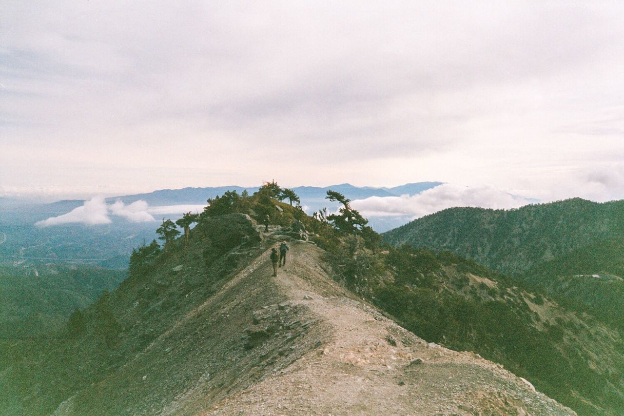 SCENIC VIEW OF MOUNTAINS AGAINST CLOUDY SKY