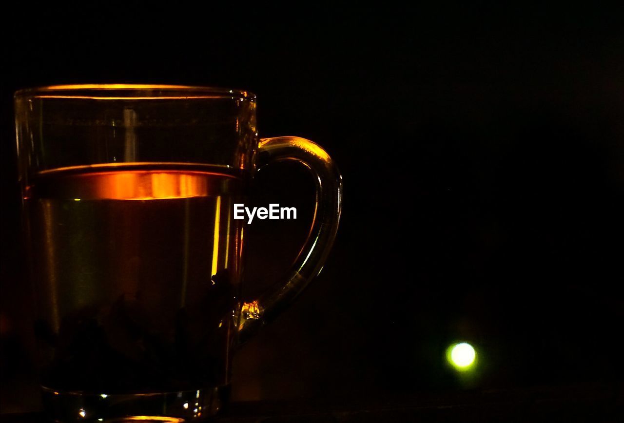 Close-up of coffee cup against black background