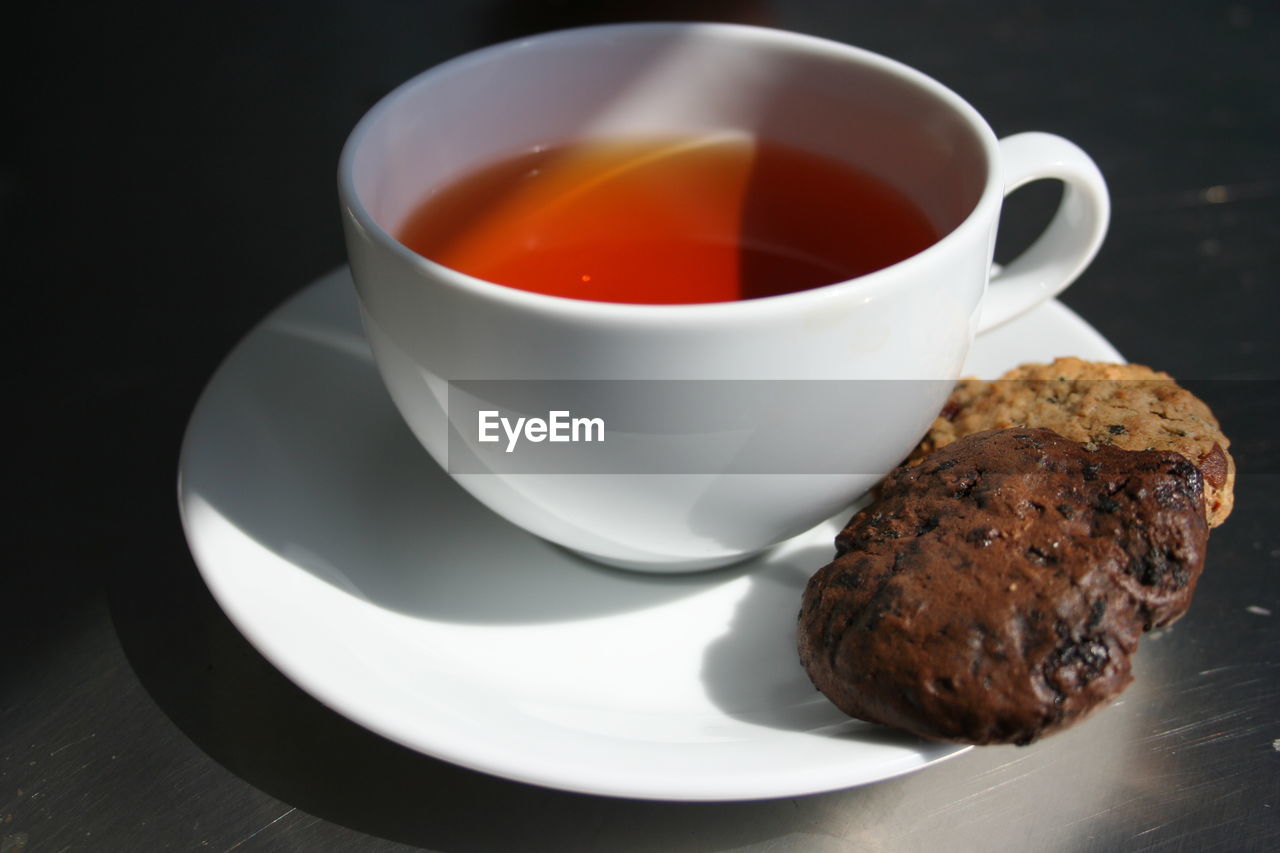 CLOSE-UP OF TEA CUP AND COFFEE