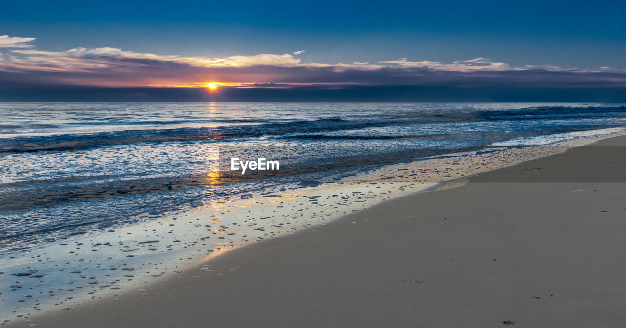 Scenic view of sea against sky at sunset
