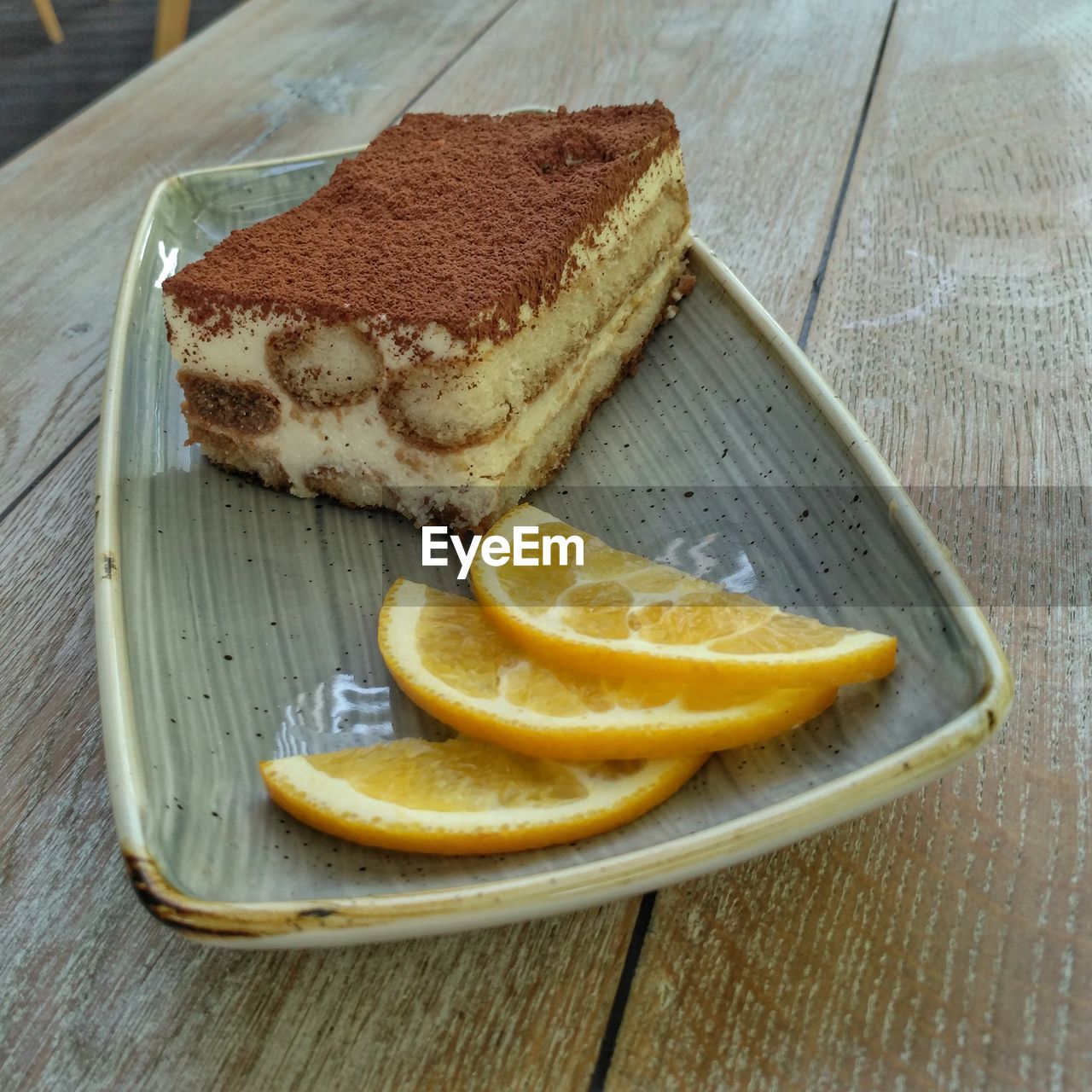 Close-up of dessert with orange slices in plate on table