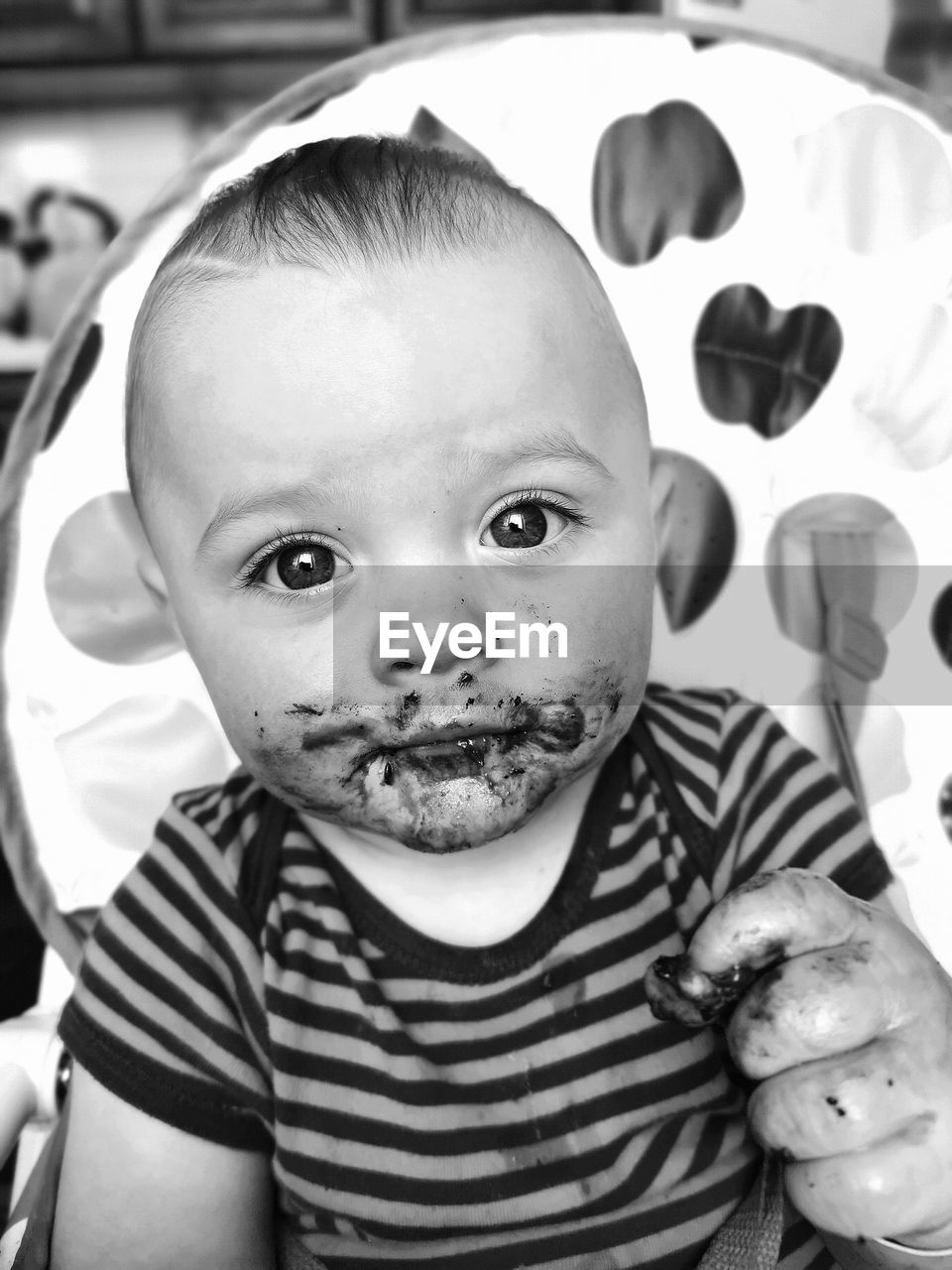 Close-up portrait of cute baby with messy face