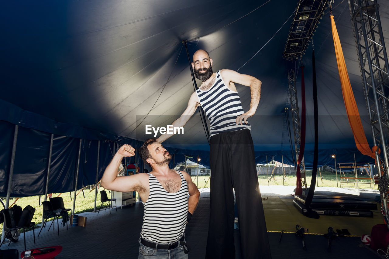 Male artists standing together at backstage