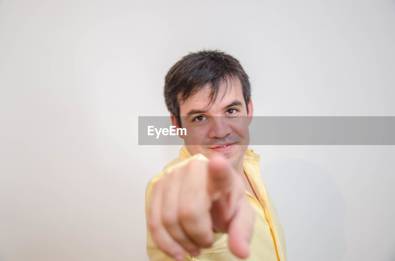 Portrait of mid adult man against gray background