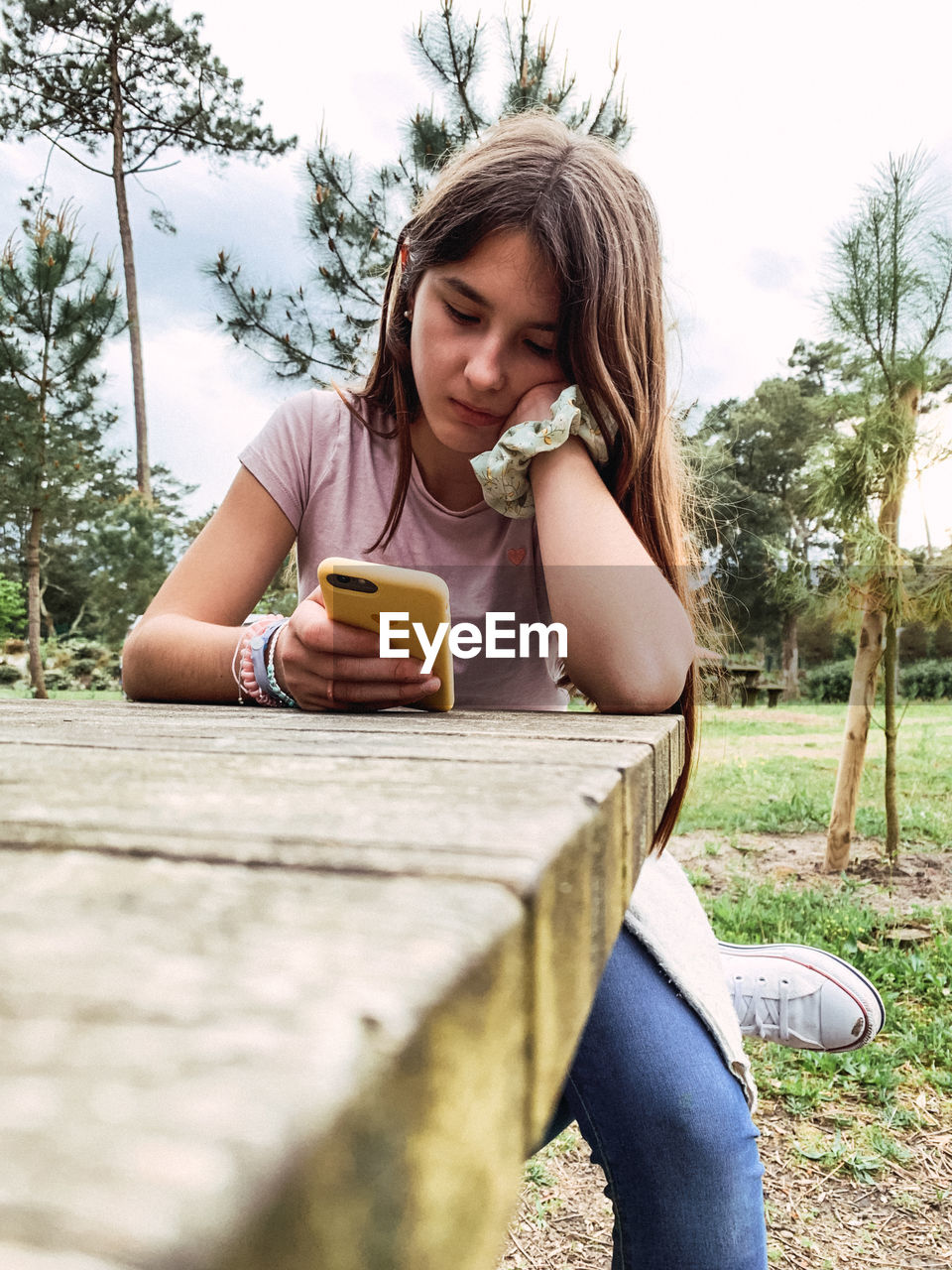 Portrait of sad adolescent with phone 