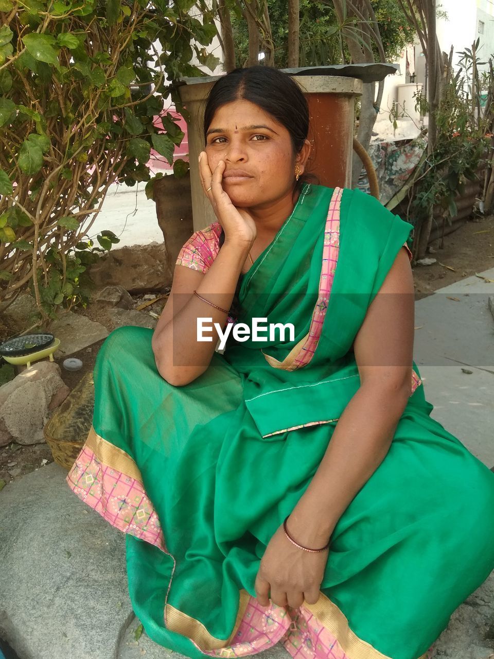 Portrait of a smiling young woman sitting outdoors