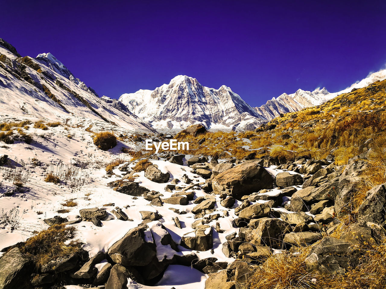 Scenic view of snowcapped mountains against clear sky during winter